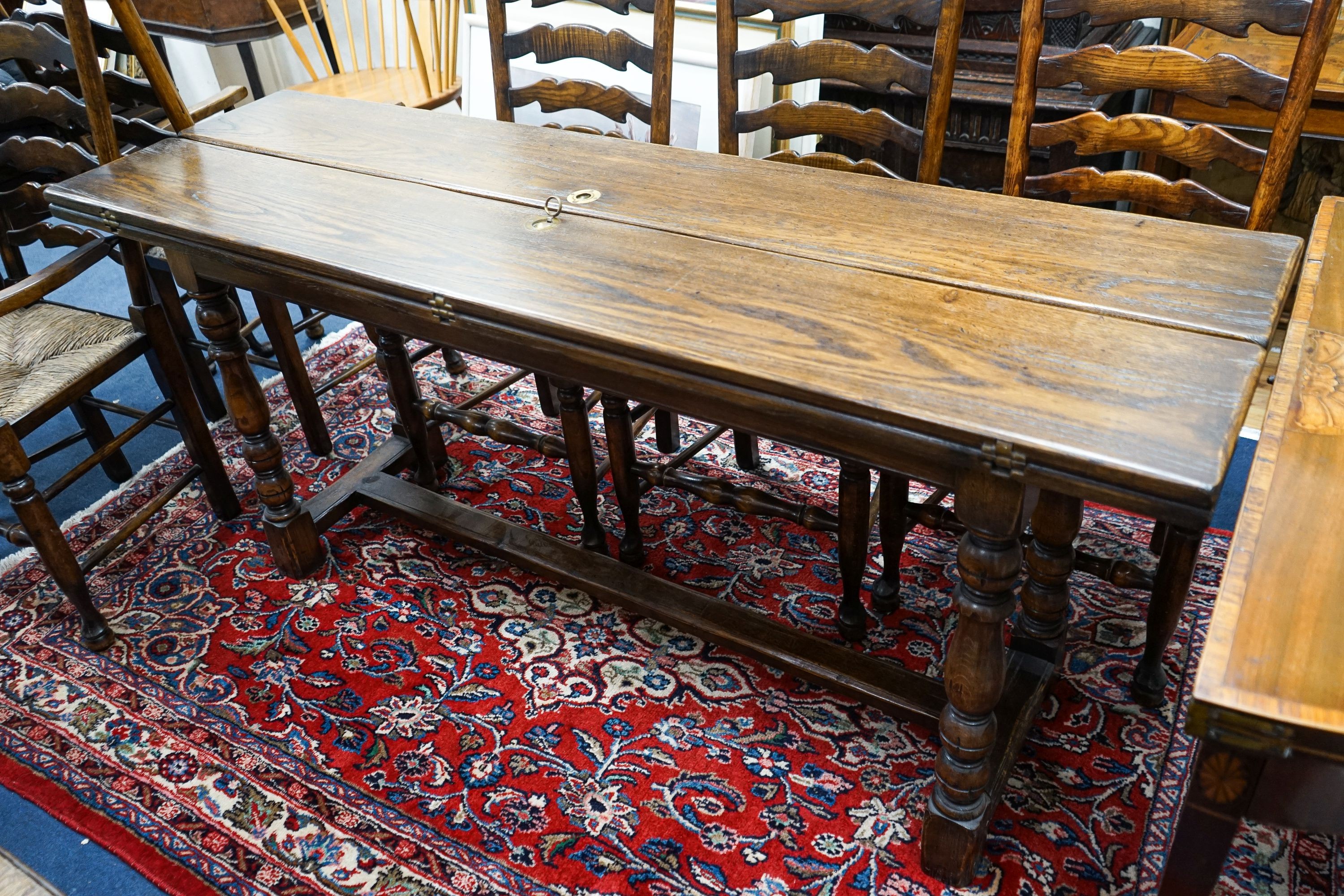 A Titchmarsh & Godwin 18th century style rectangular oak dining table with twin flap folding top, length 170cm extended, depth 99cm, height 74cm